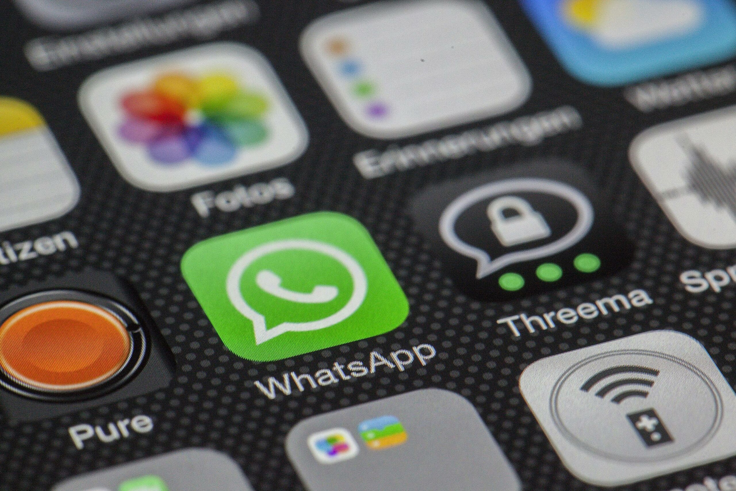 Detailed macro of smartphone screen showcasing popular app icons like WhatsApp.